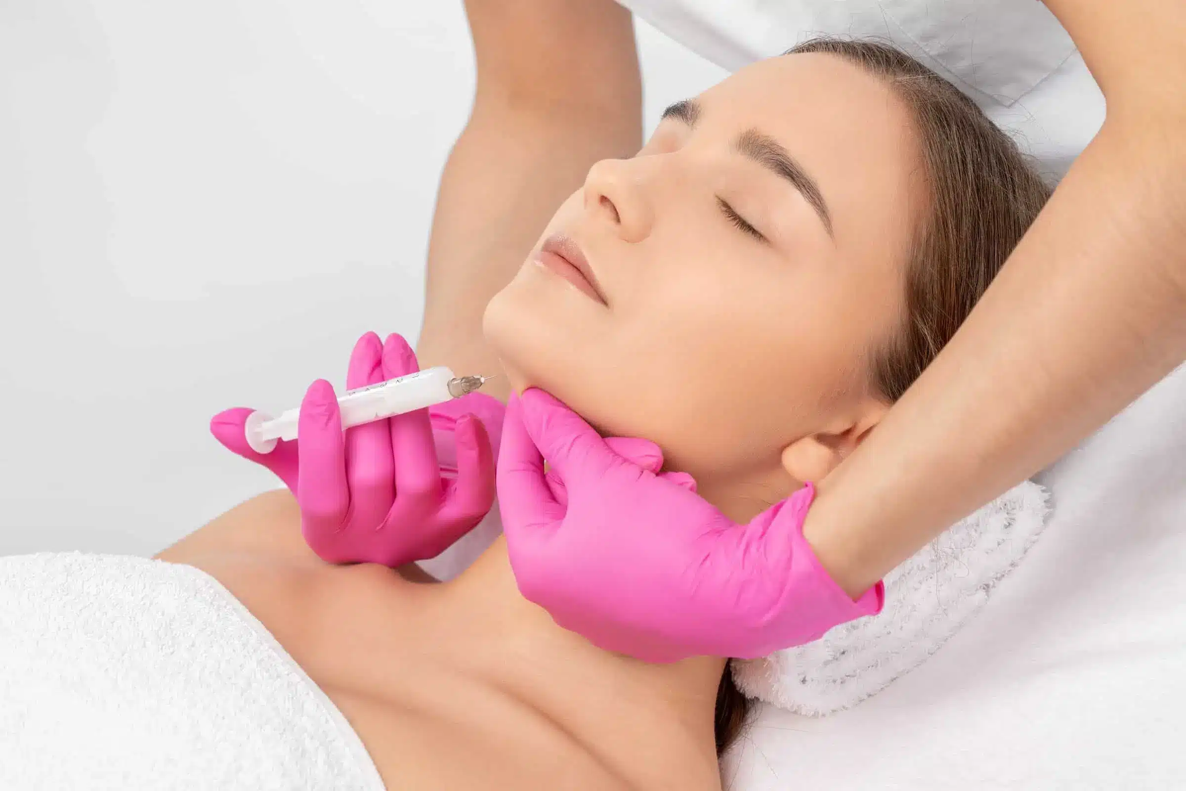 a woman receiving a Kybella injection